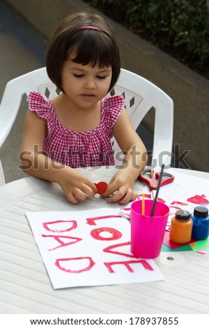 Girl draws sign that says \