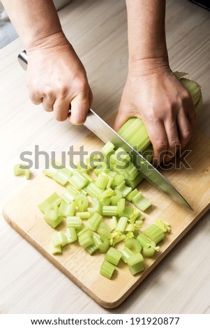 Woman hands  cut the celery