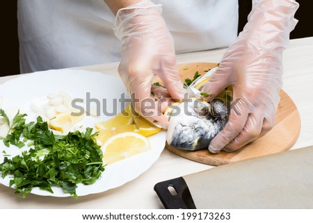 Cooked fish sea bream fish with lemon, parsley,garlic.