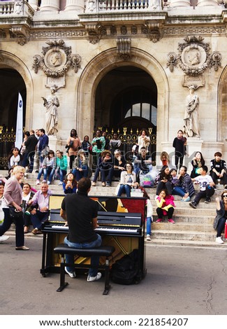 Paris, France -September 21,2014: Unidentified pianist play before public outdoors . Paris Opera