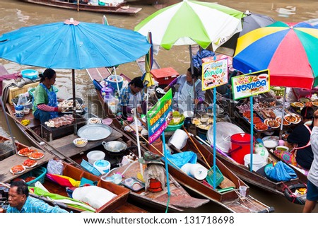 BANGKOK, THAILAND - JUNE 9: Unidentified market women sell fastfood from boat on June 9, 2012 in Amphawa river market, Thailand. The most popular river market in Thailand.