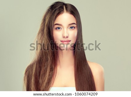 Hair care . Keratin straightening ,smoothing and treatment of the hair .  Girl with straight and smooth hair on one side of the head . The second side of the head tangled and un brushed hair .