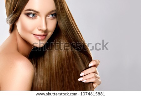 Beautiful model girl with shiny brown and straight long  hair . Keratin  straightening . Treatment, care and spa procedures. Smooth hairstyle