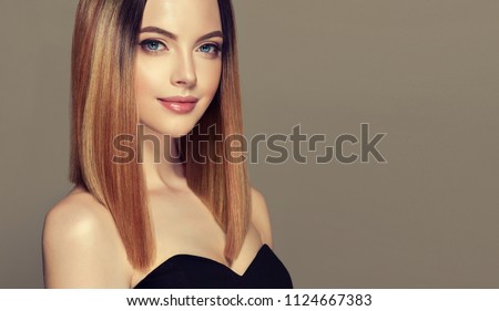 Beautiful model girl with shiny brown and straight long  hair . Keratin  straightening . Treatment, care and spa procedures. Medium length hairstyle. Coloring, ombre, shatush, balage and highlighting