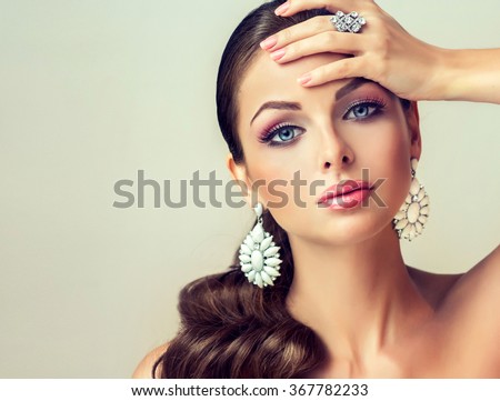 fashion woman with jewelry set . girl with fashionable jewelry , earrings  and ring