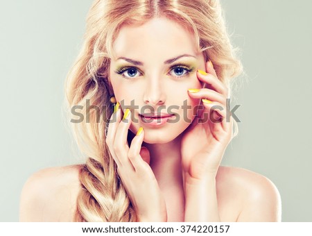 Spring   beautiful model  girl  with yellow makeup and manicure nails . Fashion make up