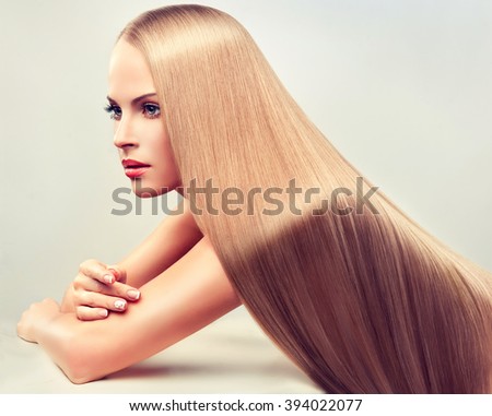 Beautiful blonde woman with long  straight  healthy and shiny hair.