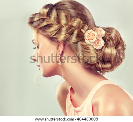Beautiful model with elegant hairstyle . Beautiful woman with fashion wedding hair and colourful makeup