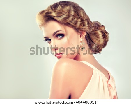 Beautiful model girl  with elegant hairstyle . Woman with fashion wedding hair .