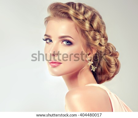 Beautiful model with elegant hairstyle . Beautiful woman with fashion wedding hair and colourful makeup