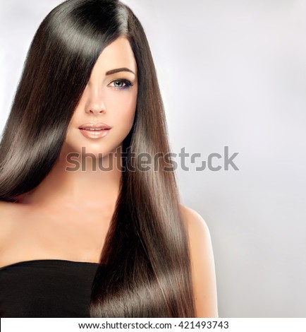 Beautiful brunette girl with long and straight black hair . Shiny smooth  and healthy well-groomed hair
