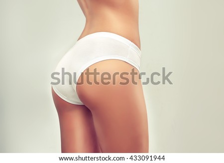 Perfect slim toned young body of the girl . An example of sports , fitness or plastic surgery and aesthetic cosmetology. .Taut elastic ass . Firm buttocks .