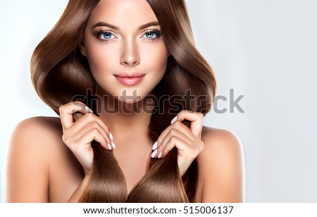 Beautiful model girl with shiny brown straight long  hair . Care and hair products .