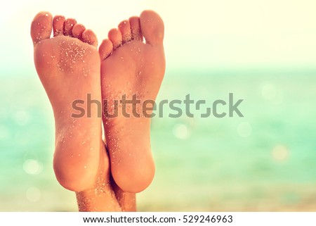 Perfect clean female feet  with sea sand on the beach .   . Spa ,scrub and foot care .
