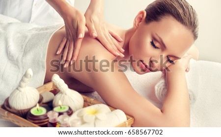 Massage and body  care. Spa body massage treatment. Woman having massage in the spa salon . Massage woman hands