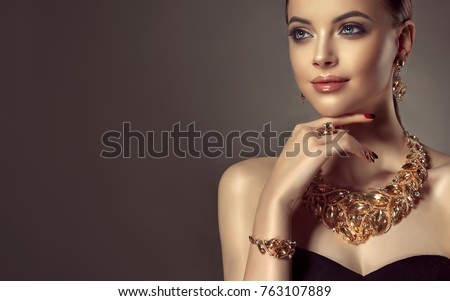Beautiful girl with set jewelry .   Woman in a necklace with a ring, earrings and a bracelet. Beauty and accessories.