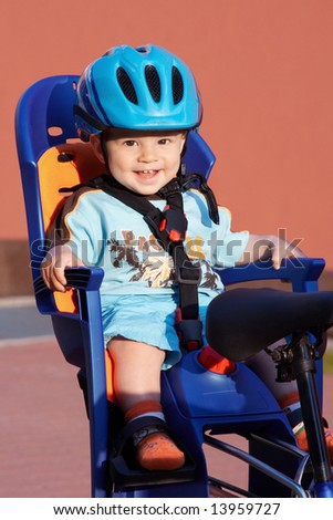 happy baby in bicycle chair