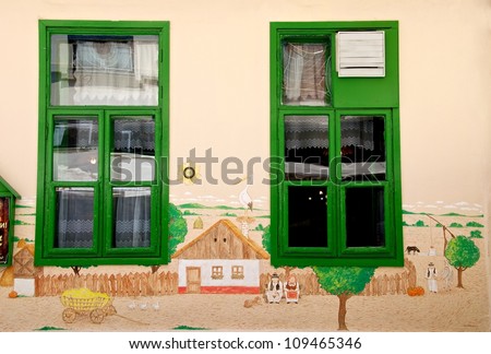 Architecture details. Colorful windows fragment.Street scene with the house windows. Vintage windows, color picture. Green framed windows. Village house. House with colorful windows. Exterior
