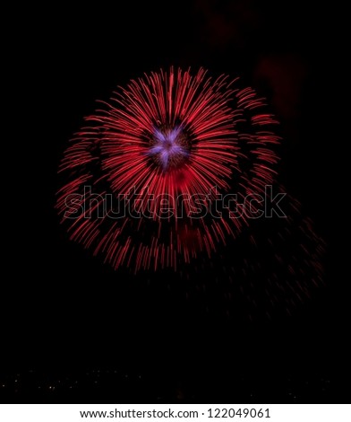 Beautiful red color firework with pink flower in the middle imagination, light art in black background, festival and event time, New year, Independence day, red explosion, fireworks festival,light art