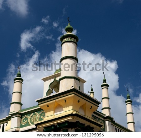 Front view of top of medina and minarets, typical arabic religion building on blue cloudy sky background, arabic, church