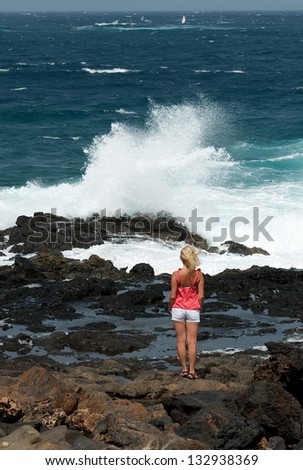 Young woman lady looking to the wavy sea, woman looking to the sea, young girl 18 age near shore,woman looking to the waves, woman and sea, blond woman, solitude, european woman, summer holidays