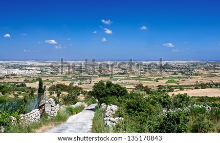Malta landscape with the fields, olive trees,plantations,yellow stones houses,view to the sea from the top to all Malta island with the blue sky background, Malta landscape, maltese coastline, Malta
