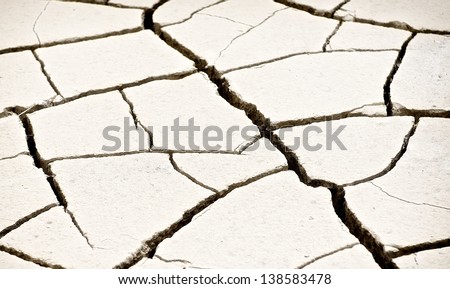 Warm light concrete background, rock pieces texture, patterned crack concrete, cracked concrete texture closeup background, focus  to the centre