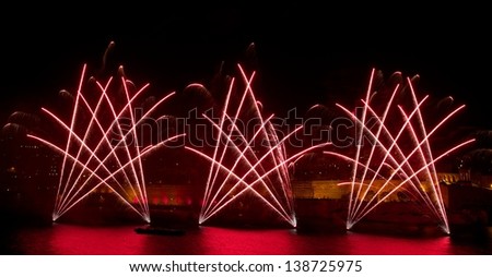 Colorful fireworks over night sky,red fireworks lines in black background and city view,fireworks in Malta, Malta fireworks festival, Malta, dark sky background red reflection on water, long exposure