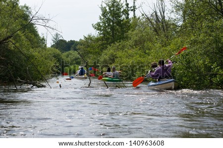 River fragment  with kayaks boats in water,European nature,river fragment close up, summer sport, wild river with trees and bushes, sport, sport activities, wild nature, Lithuania, kayak tour,boats