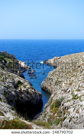 Bay view in Malta island with boats and clear blue sea and sky background, touristic destination in Malta, Blue Grotto, popular place in Malta, maltese landscape, Malta, Europe