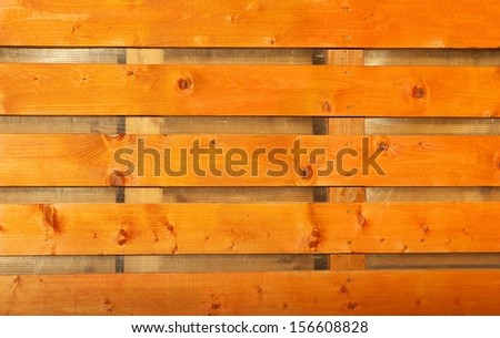 Wood plank yellow orange texture background, yellow wood texture, wood gates fragment, dirty wood plank texture. Industry. Cropped photo.