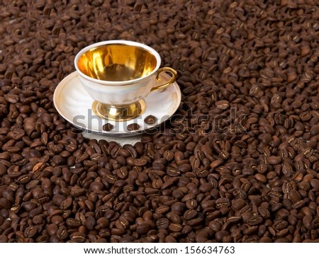 A cup of coffee bean as background, empty cup between of roasted coffee beans as a background composition, Cup with coffee bean\'s background, selective foes, natural light