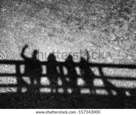Shadows Of Four People On Grass Pavement.People Shadows On The Bridge, Artistic Photo In Black And White, B&Amp;W, Selective Focus.Contrast, People Shadows On Sunny Day, Abstract Photo.Meeting Of Friends