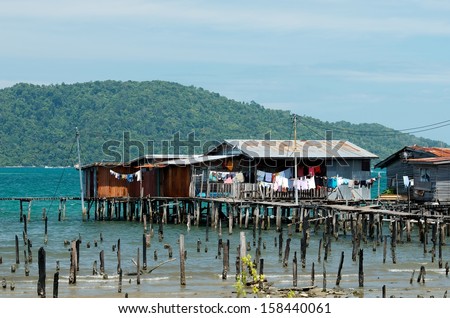 View of a poor housing area at Malaysia, Kota Kinabalu district. The poor area in the sea in Malaysia.Squatter homes in Philippines. Wooden poor houses in the sea. Selective focus. Poor life