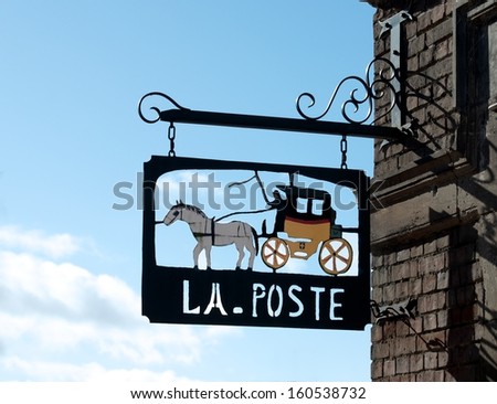Exterior detail, post office sing in France, decorative detail, metal decorative sing Post in France, Post sign, exterior, post office, exterior fragment with blue not clear sky background