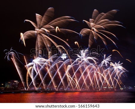 Fireworks,colorful fireworks background,fireworks explosion in dark sky with city sillouthe and colorful reflect on water,fireworks in Riga,Latvia,long exposure fireworks,Independence, explode concept