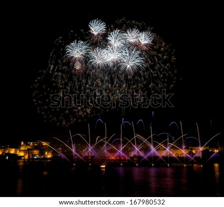 Fireworks,colorful fireworks background,fireworks explosion in dark sky with city sillouthe and colorful reflect on water,fireworks in Valletta,Malta,long exposure fireworks,Independence, explode