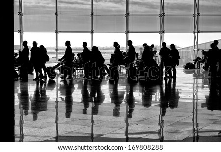Shadows of people on building background. People shadows with reflection on the ground. Artistic photo in black and white, B&W, selective focus.Contrast, people shadows on sunny day