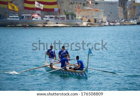 VALLETTA, MALTA - SEPTEMBER 8: traditional boats regatta in Valletta in Mediterranean sea on Sep 8, 2013. Popular regatta in Malta. Traditional sport in Malta. Boat team. Kalkara
