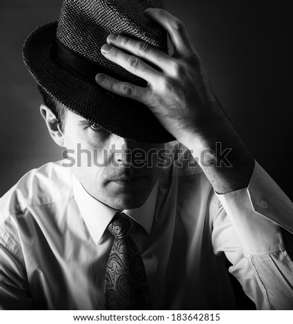 Man with the hat in black and white photo, artistic man photo, man portrait close up, man fashion photo, man isolated in dark background, concept, artistic photo, model male, man in 35 years, serious