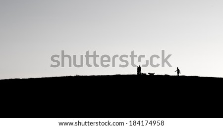 People and dogs silhouettes on a hill in night light, family walking in dark evening, evening darkness and people walking on a hill, small people silhouettes on night on the hill, family, activities