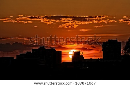 Building silhouettes in red orange cloudy sunset background, dark photo, dramatic sunset, city scene on sunset, Vilnius, Lithuania