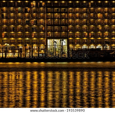 Night urban scene with gold reflections on a water, night city with reflections in water, night urban fragment photo, conceptual photo, artistic, urban scene on night time, Sliema in night time, Malta