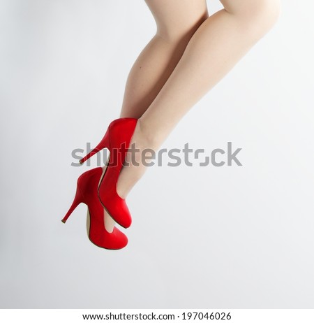 Beautiful woman legs with red shoes, Perfect female legs with red high heels isolated on grey background, woman legs with space for text, running woman legs