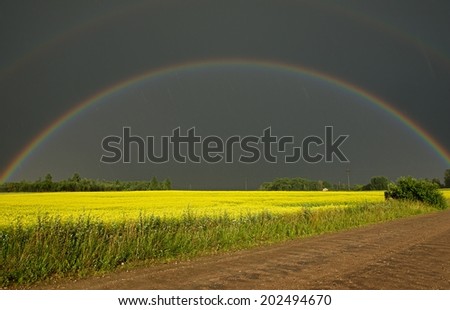Dramatic view of storm weather conditions with the double rainbow, rainy day with the rainbow, double rainbow, dramatic scene after storm, rainbow and yellow field, Lithuania, lithuanian landscape