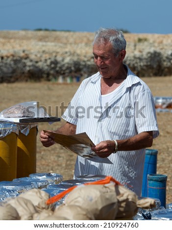 ZURIEQ, MALTA - JULY 26: worker of fireworks factory preparing material for fireworks festival in Malta on July, 2014. Maltese traditions, preparation for fireworks, bulb of fireworks powder close up