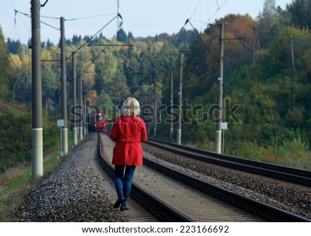 Woman waiting train in colorful autumn background, european woman waiting train near railway,  woman in red, woman walking near railway, solitude, emotions, woman and train, train station, train going