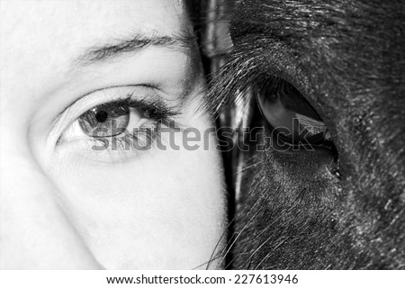 Eyes of girl and horse in black and white photo, artistic photo of horse and woman eyes close up, only eyes cropped