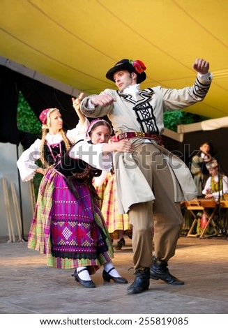 VILNIUS, LITHUANIA - July 6: Lithuanian Folk music group Lietuva gives concert on July 6, 2013 in Vilnius, Lithuania.Lithuanian Folk music group in traditional costumes dancing in concert.