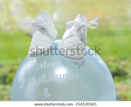 Little white shoes of baby on baptism day, small baby shoes, baptism celebrity, children party fragment photo, preparation for baptism